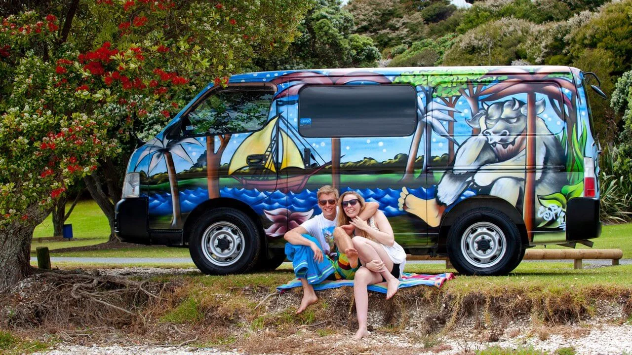 Ein Pärchen sitzt vor einem Escape Camper