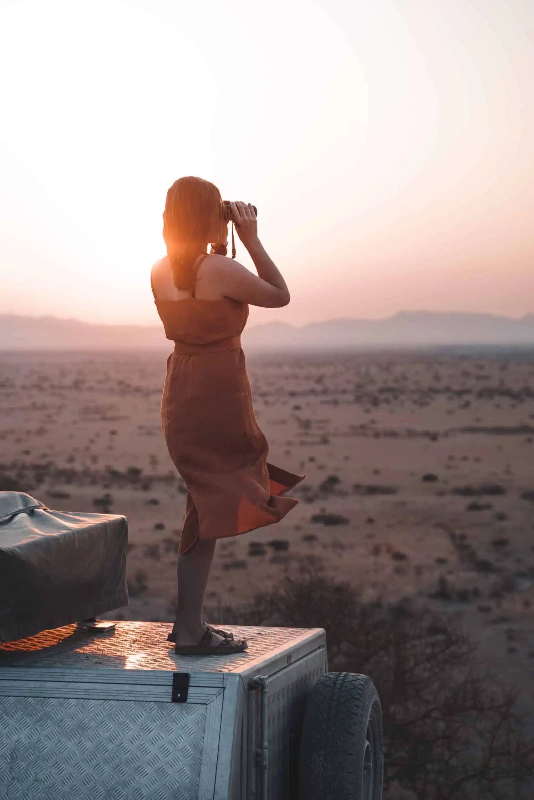 Lea Milde on the rooftop of a campervan in Namibia.