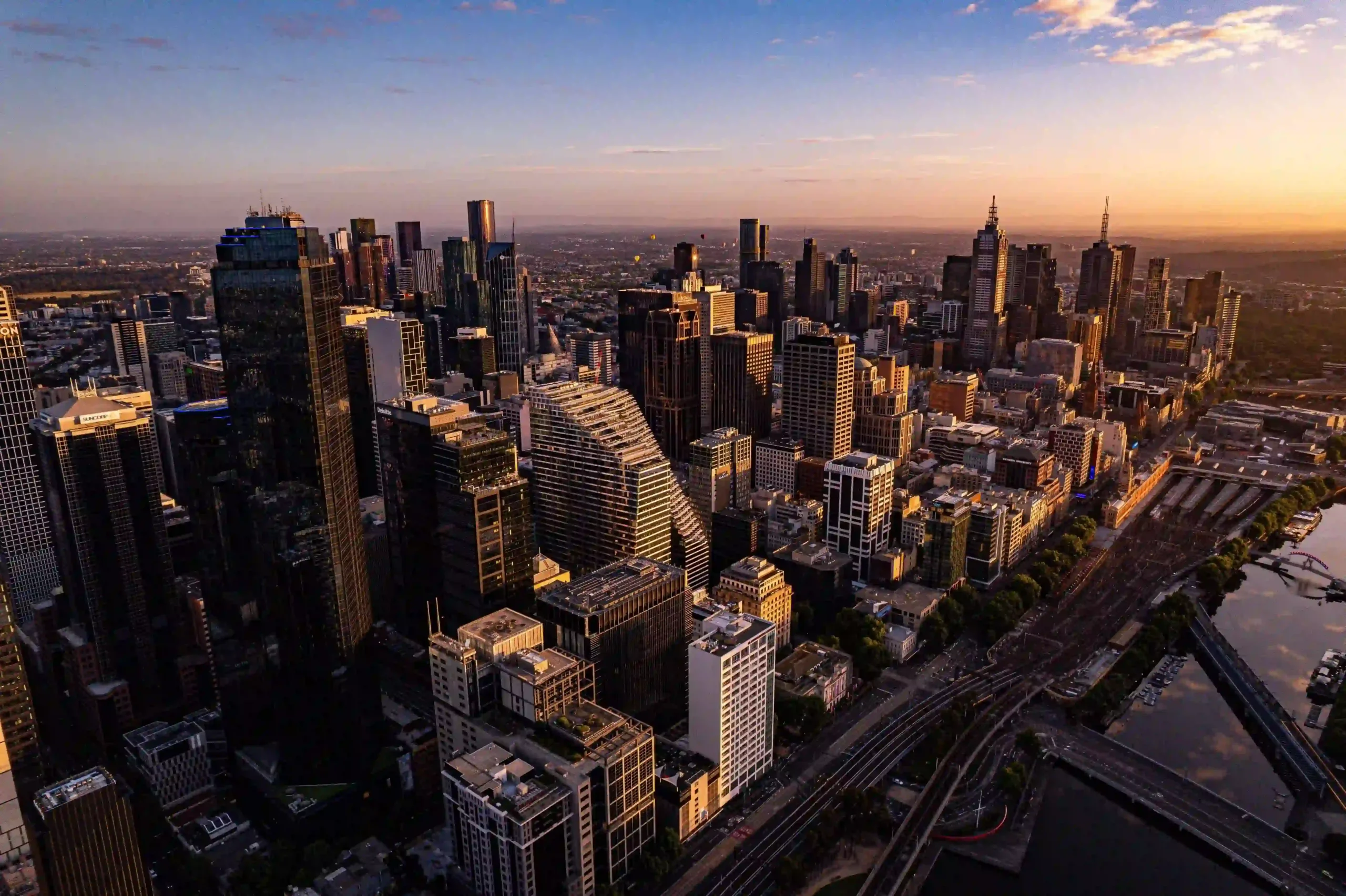 Aerial view of the Melbourne city skyline during sunset.