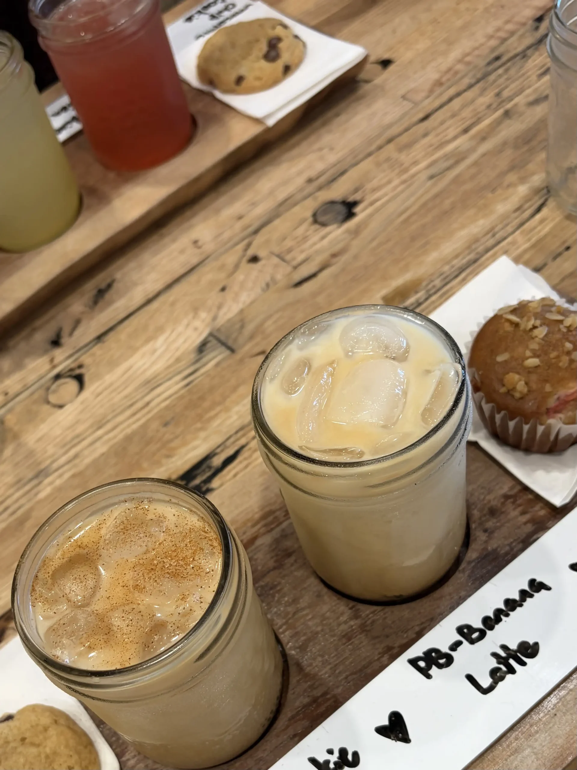 A table with iced lattes served in mason jars.