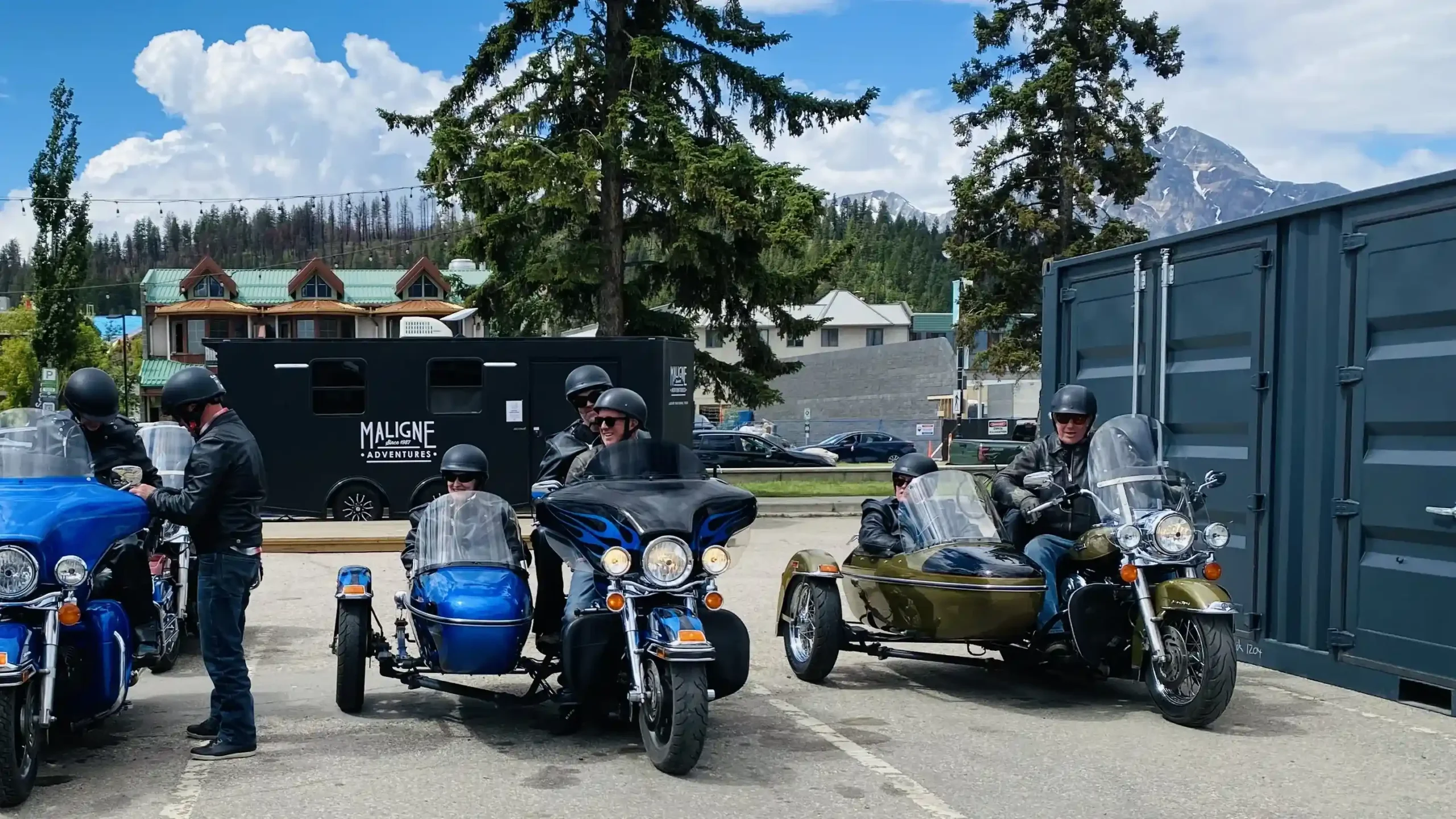 iders preparing for a mountain excursion with Jasper Motorcycle Tours on classic Harley-Davidson sidecar rigs.