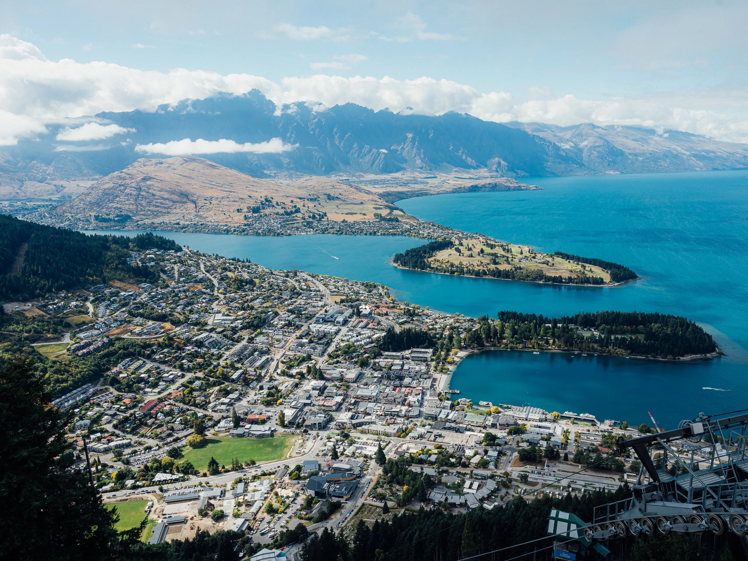 Panorama of Queenstown framed by water and peaks.