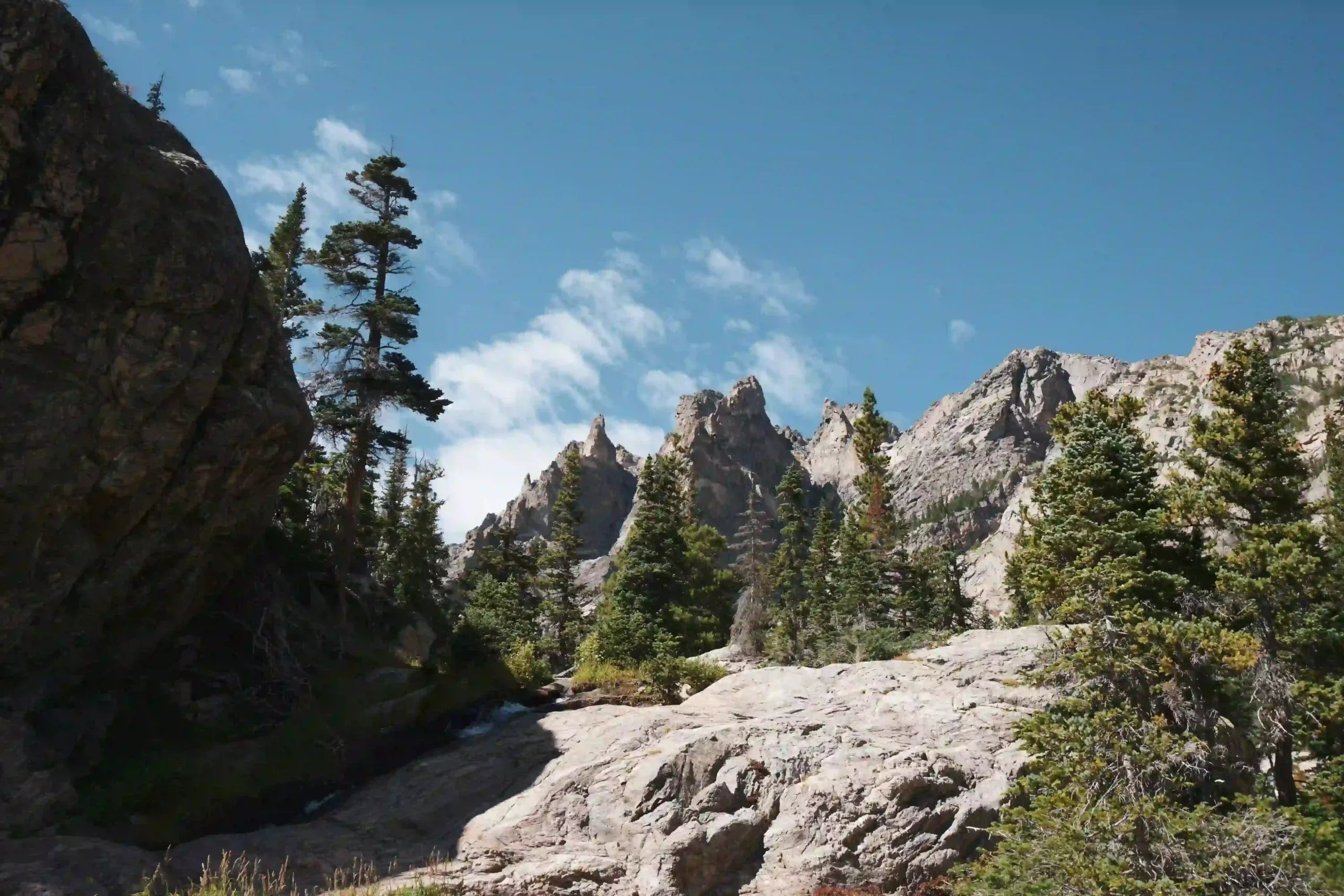 The imposing granite spires and pine forests of Rocky Mountain National Park.