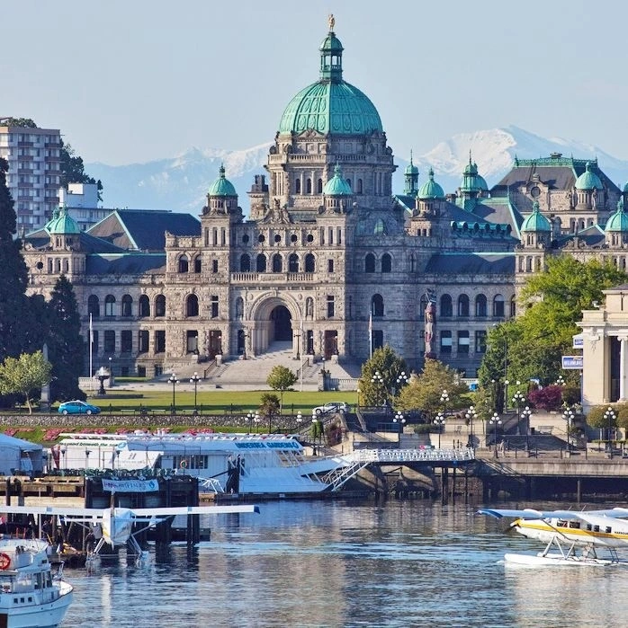 The Parliament Building sits above Victoria’s busy harbour as floatplanes arrive.